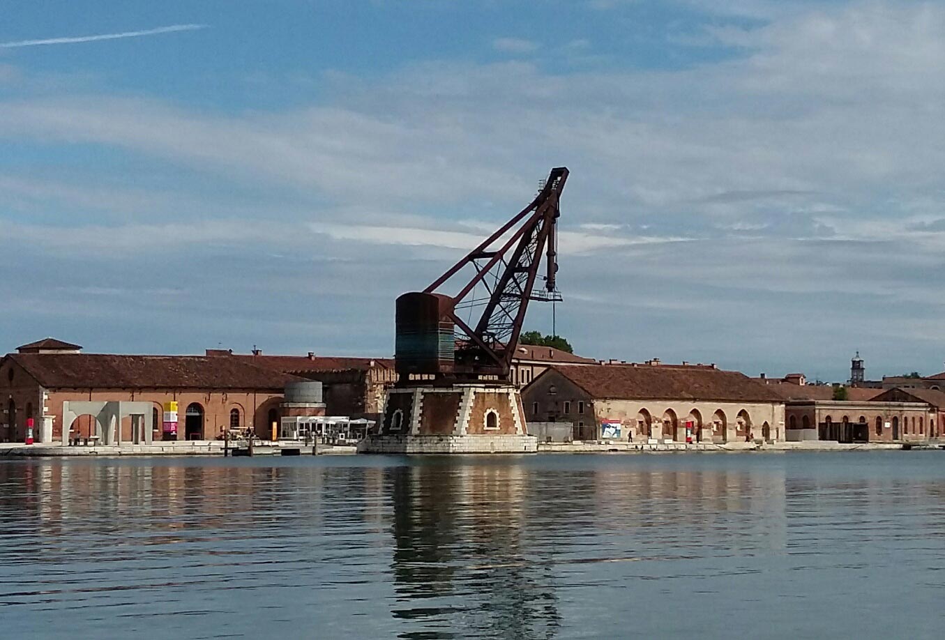 Long shot of the Arsenale, looking across the water to Tesa dell'Isolotto, showing the 19th century hydraulic crane located outside the New Zealand Pavilion.