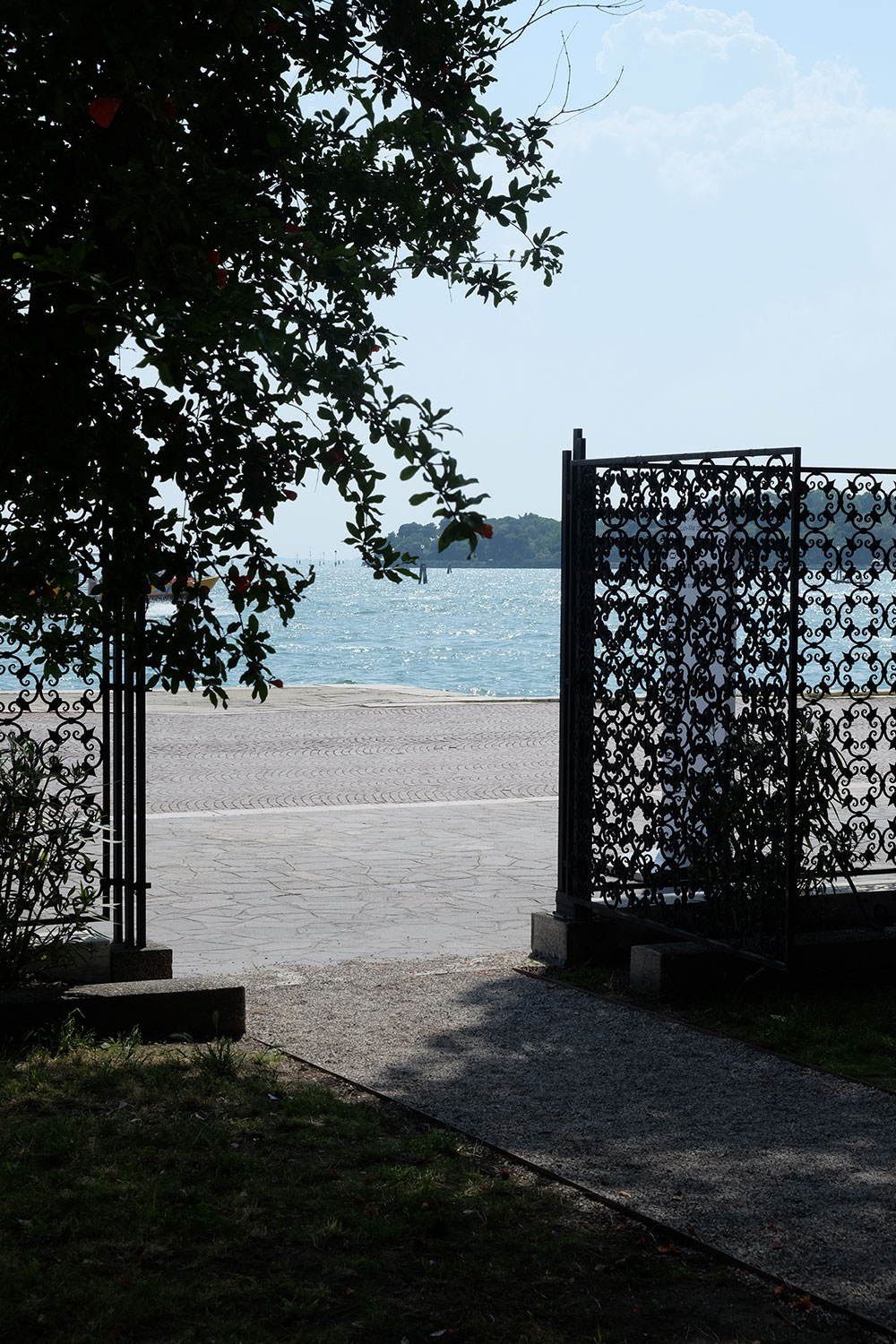 pavilion lagoon behind the Riva dei Sette Martiri, viewed through iron gates from the courtyard of the Palazzina Canonica