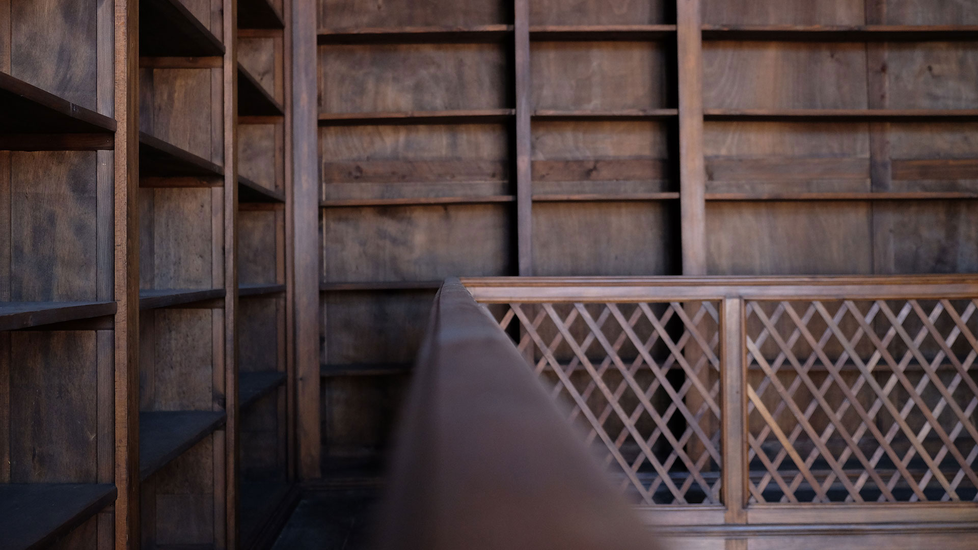 wood-stuff Close up of empty, wooden library shelves and banister inside the of the Palazzina Canonica