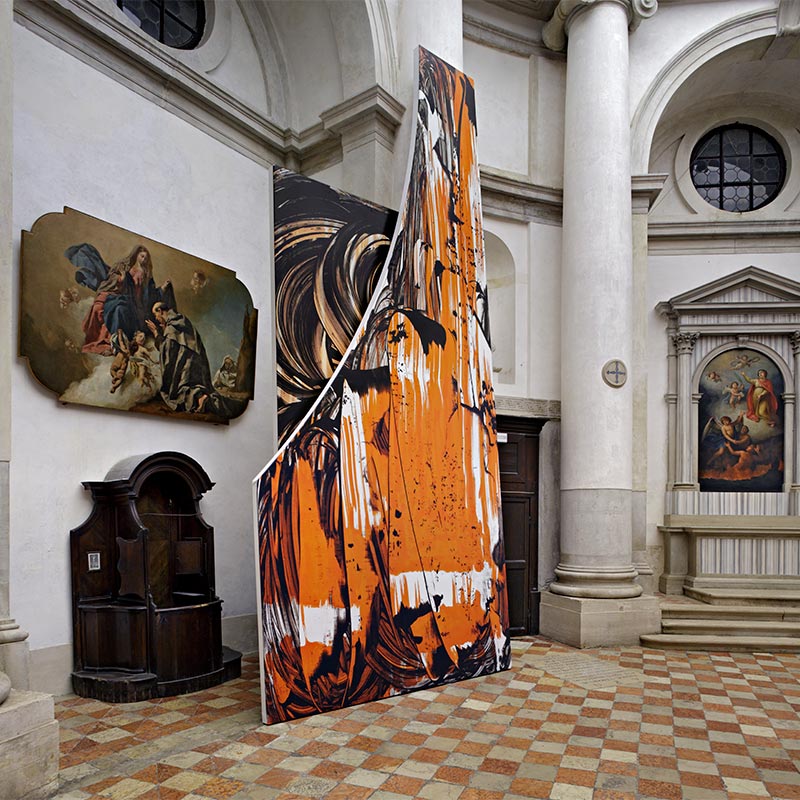 Two large fragmented vinyl sculptures with printed enlarged brush strokes of black, white and orange paint resting against a pillar of the circular neo-classical church contrasting with the original classical religious paintings in background.  
