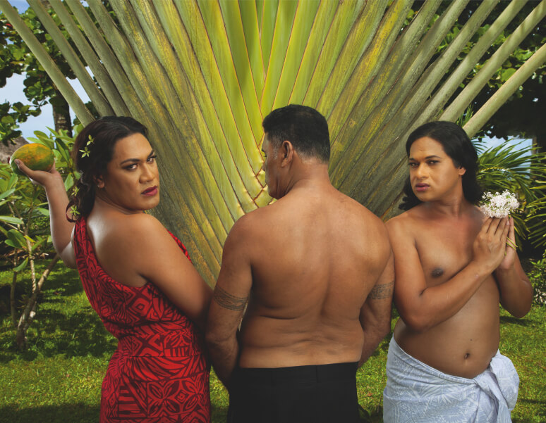 Three Fa‘afafine (Sāmoa’s third gender) in front of a woven flax leaf. 
